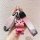 A hand holds a pink nissan qashqai key cover with a glittery bear charm and a matching strap, showcasing its stylish and luxu...