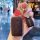 A hand holds a stylish leather key cover for jaguar models, featuring a strawberry charm and a meetluck tag with a sparkling ...