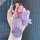 A hand holds a sparkling purple key cover for the ora good cat gt, adorned with a happy bear charm and a pink ring, perfect f...