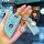 A hand holds a light blue bmw leather key fob case with gold accents, featuring free engraving and decorative charms, designe...