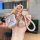 Elegant wuling binguo plus key cover for women, featuring a pink leather strap, gold accents, and a heart-shaped charm, perfe...