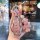 A hand holds a sparkling pink chery jetour x70 plus key cover adorned with a glittery teddy bear charm, set against a blurred...