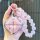 A hand holds a stylish wuling binguo key cover for kiwi ev & yun duo, featuring a pink textured design with a silver frame an...