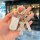 Elegant yamaha nmax155/xmax300 key cover featuring a sparkling teddy bear charm and leather strap, perfect for stylish riders...
