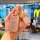 A hand holds a pink honda key cover with gold accents and a bow charm, designed for cr-v, accord, hr-v, and civic models, dis...