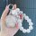 A hand holds a nio u2 key cover featuring a sparkling silver design with pearl-like beads and a heart-shaped charm, showcasin...