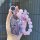 A hand holds a stylish mg5 key cover adorned with sparkling purple beads and a decorative charm, perfect for scorpio zodiac e...