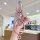 A hand holds a pink infiniti nissan key cover for altima, qashqai & sylphy, featuring a braided strap and decorative charms, ...
