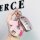 A hand holds a stylish wuling hongguang mini ev key cover, featuring a pink leather horse charm with silver accents and a sle...