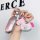 A hand holds a zerorun c11 key cover in pink premium leather, featuring a decorative rocking horse charm with rhinestone acce...