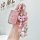 Elegant pink jaguar land rover key cover for women, adorned with a decorative bow and beaded charm, perfect for stylish car o...