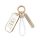 Elegant infiniti q50l key cover with gold accents, featuring a white leather strap and decorative charm for a stylish womens ...