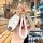 Elegant infiniti q50l key cover with gold accents and a braided white rope, designed for women, showcased in a cozy café sett...