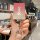 A hand holds a sleek nio es6/es8/ec6 key cover with a gradient red-to-silver design and a sparkling ring charm, set against a...