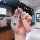 Elegant bmw key cover in premium leather, designed for 530li, x5l, 325, and ix3 models, featuring a stylish pink strap and sp...