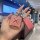 A hand holds a stylish zeekr 001 007 009 key cover, featuring a pink glittery design with a bluetooth-enabled lock icon and a...