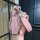 A hand holds a geely xingyue l key set featuring a pink leather key fob with a scratch-resistant buckle and a matching pink l...