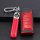 Red and black leather key cover for gac trumpchi gs4, featuring a braided red strap and functional buttons, displayed on a te...
