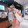 A hand holds a stylish nissan key cover with a fashion strap, designed for altima, qashqai, sylphy, and more, featuring a sle...