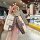 Hand holding a tiejiangjun kd vvdi foldable key cover with a louis vuitton-inspired design, featuring a teddy bear charm and ...