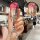 A hand holds a sleek, gradient pink wey blue mountain key cover for the 2023 wey lanshan, featuring a front view with a lock ...