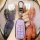 A hand holds a light purple chery tiggo 8 plus key cover, featuring a sleek design with four buttons and a silver carabiner, ...