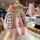 Elegant pink nissan x-trail key cover featuring a stylish pattern, crystal embellishments, and a convenient wrist strap for m...