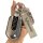 A hand holds a sleek wuling hongguang mini ev key cover, featuring a metallic finish and a matching keychain with the wuling ...