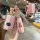 Elegant pink mazda 3 key cover with gold accents, featuring a patterned strap and a front view showcasing its stylish design ...
