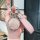 A hand holds a stylish aya premium key cover for nio u/s/l/v/gt (2023–2024), featuring a glittery pink orb and a pink leather...