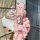 A hand holds a pink chevrolet cruze key cover with a glittery finish and a decorative bow keychain, showcasing its stylish de...