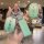 A hand holds a stylish green emma e350 key cover for an electric scooter remote, featuring a gradient design and a decorative...