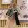 Elegant perodua myvi axia key cover featuring a stylish design with a black leather strap and decorative elements, perfect fo...