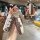 Elegant mazda key cover featuring a stylish louis vuitton-inspired design with a decorative strap and back view showcasing de...