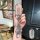 A hand holds a stylish wuling hongguang mini ev key cover in a pastel game boy design, adorned with sparkling crystals and el...