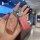 A hand holds a glittery pink mg 6 key cover with a diamond-embellished charm and a leather tag labeled kasparian california, ...