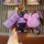 A hand holds a set of keys featuring a purple key cover shaped like an electric scooter, accompanied by two bear-themed keych...