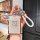A hand holds a sleek zeekr card key cover with a glittery finish and zeekr logo, featuring a braided white strap and decorati...