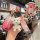 A hand holds a red buick key cover for the 2024 regal, lacrosse, and envision s, featuring a cute bear charm and a patterned ...