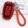 Red lincoln key cover for aviator, corsair, mkc, mkz & navigator, featuring a braided cord and sleek design, displayed on a k...