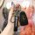A hand holds a sleek black key cover for the baic senova d50, d70, x55, and x65 models, featuring a senova strap and a matchi...
