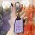 A hand holds a sleek, purple vw key cover for jetta, passat, and golf, featuring a metallic vw logo and a secure carabiner, s...