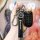 A hand holds a sleek borgward bx5/bx7 smart key cover, featuring a premium leather strap with the brand logo and a protective...