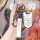 A hand holds a sleek borgward bx5/bx7 smart key cover, featuring a premium leather strap with the brand logo and a protective...