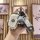 A hand holds a vinfast vf8 vf3 premium key cover, featuring a sleek white design with a cute bear charm and a stylish wrist s...