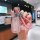 A hand holds a stylish pink leather key cover for the 2024 toyota camry hybrid elite, featuring a braided strap and decorativ...