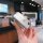 A hand holds a sleek, silver vw key cover for models like passat, tiguan, and golf 7, featuring a premium leather design with...