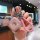 A hand holds a stylish baojun kiwi ev key cover for yun duo qing kong, featuring a pink diamond-shaped design with silver acc...