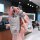 A hand holds a sleek, silver baojun 510 key cover with a white braided rope and a cute bear charm, showcasing its premium pu ...