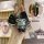 Hand holding a malaysia toyota flat key cover with a luxury leather sleeve and a cute bear charm, showcasing both front and s...